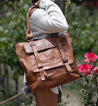 A woman holding a Bed Stu Big Fork tote bag.