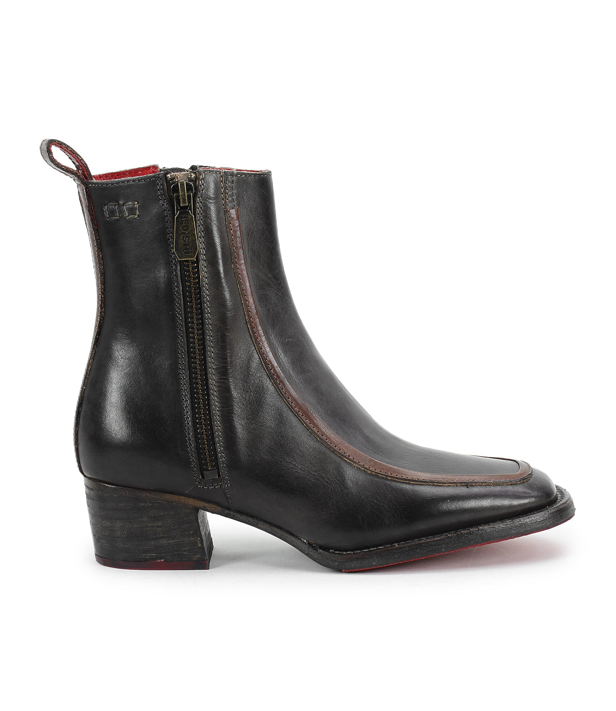 The Bitsy by Bed Stu is a black, hand-finished leather ankle boot featuring a low stacked wooden heel, side zipper, brown piping, back pull tab, and a slightly pointed toe for extra style.
