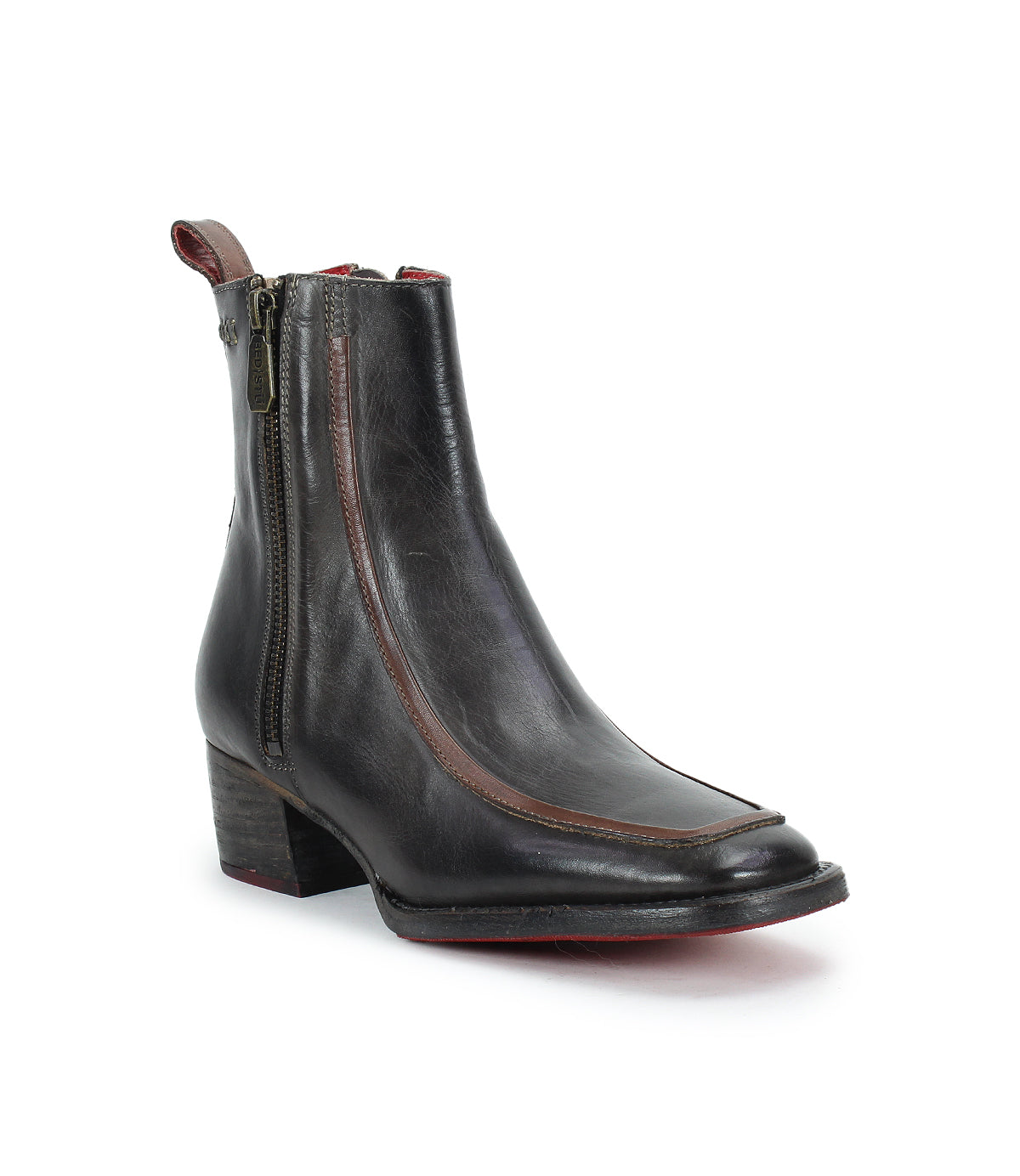 The Bed Stu Bitsy is a black, hand-finished leather ankle boot featuring a side zipper, brown accent trim, stacked wooden heel, and pointed toe.