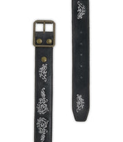 The Blaze JB by Bed Stu is a black full-grain leather belt featuring an antique-finished buckle and decorative white embroidered scrollwork along its length.