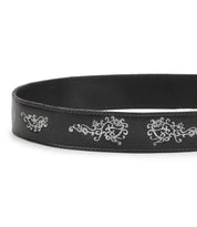 The Bed Stu Blaze JB is a black full-grain leather belt with white embroidered scrollwork, visible edge stitching, and an antique-finished buckle.