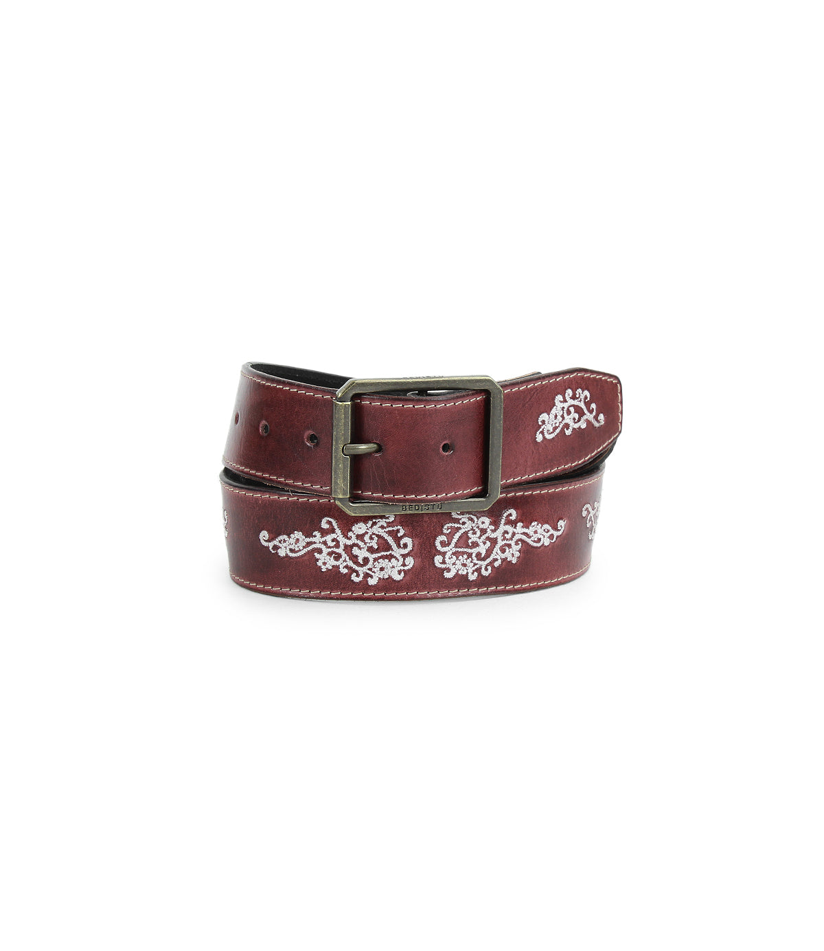 The Bed Stu Blaze JB is a brown full-grain leather belt with white embroidered scrollwork and an antique-finished buckle, shown coiled on a white background.
