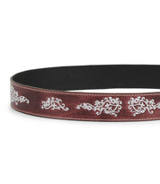 The Blaze JB by Bed Stu is a brown full-grain leather belt with white swirling embroidered scrollwork along the edge, finished with an antique-style buckle.