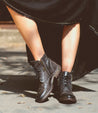 A woman wearing a black Bed Stu Bonnie II boots.