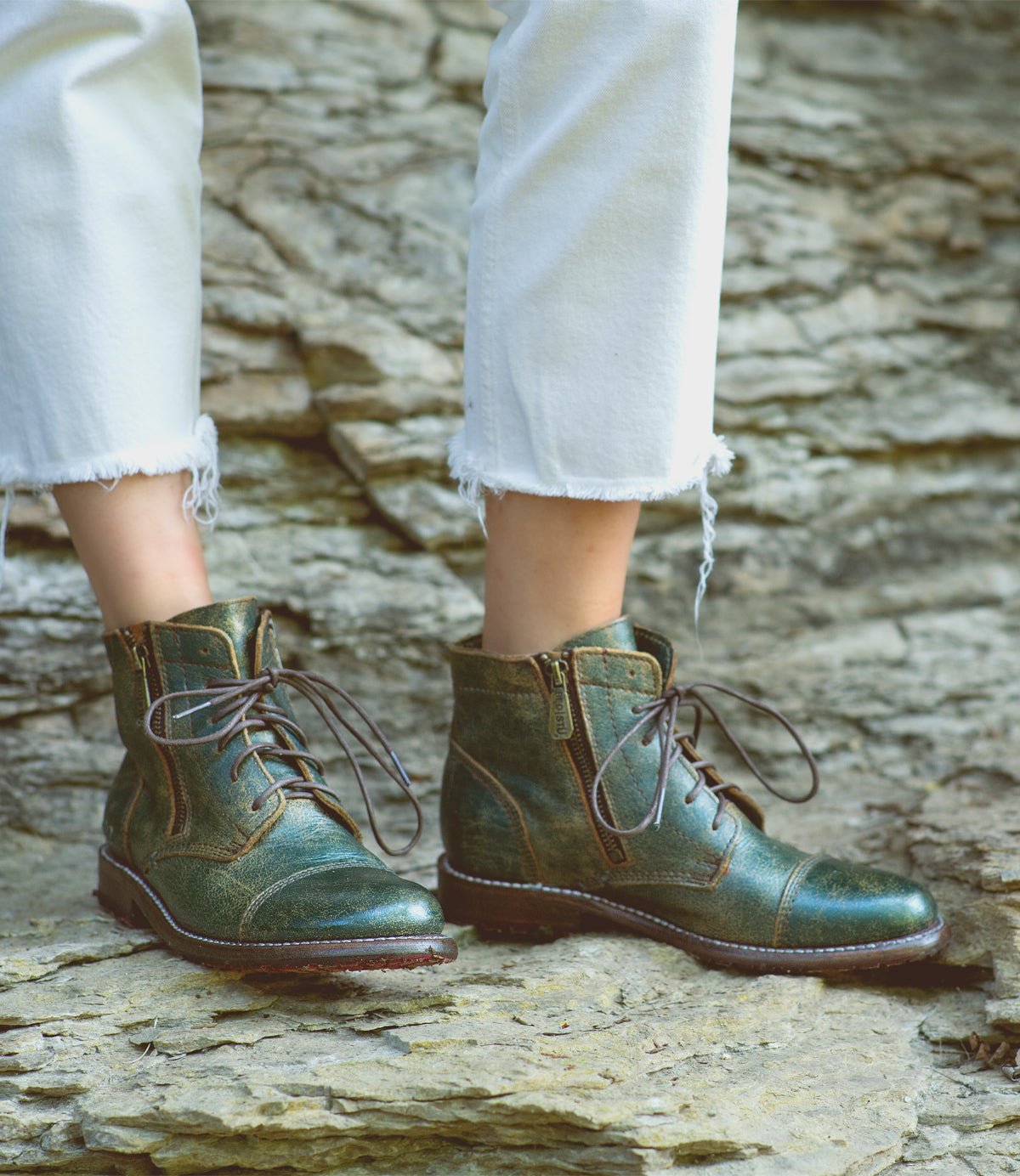 A woman wearing Bed Stu Bonnie II teal leather laced boots.