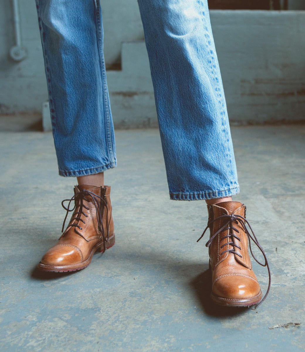 A woman wearing a pair of Bed Stu Bonnie II tan boots.