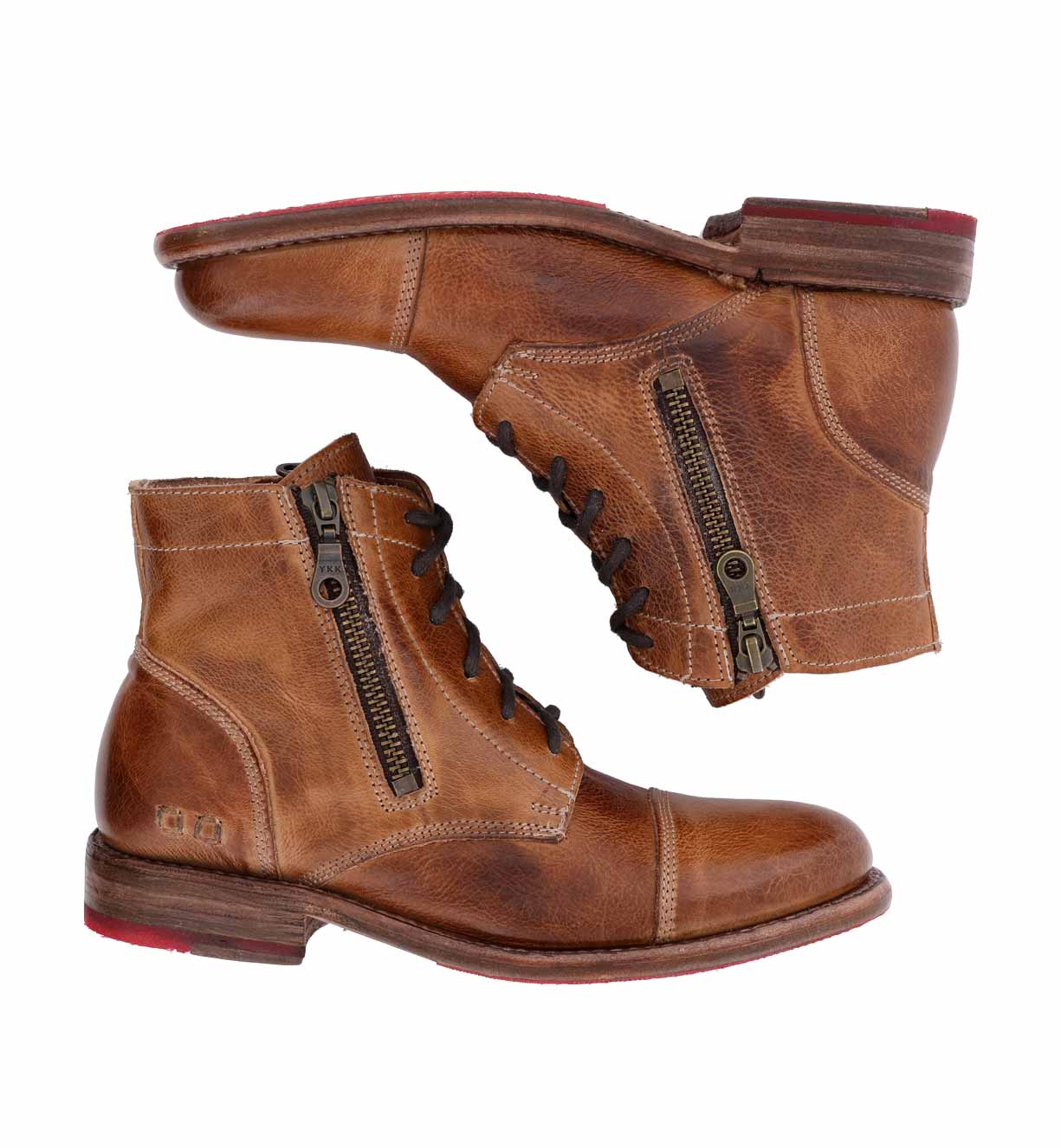 A pair of Bonnie Bed Stu enduring brown lace-up combat ankle boots with red soles.