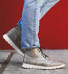 A person wearing a pair of Bowery II jeans and a pair of Bed Stu shoes.