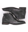 A pair of Bed Stu black leather boots on a white background.