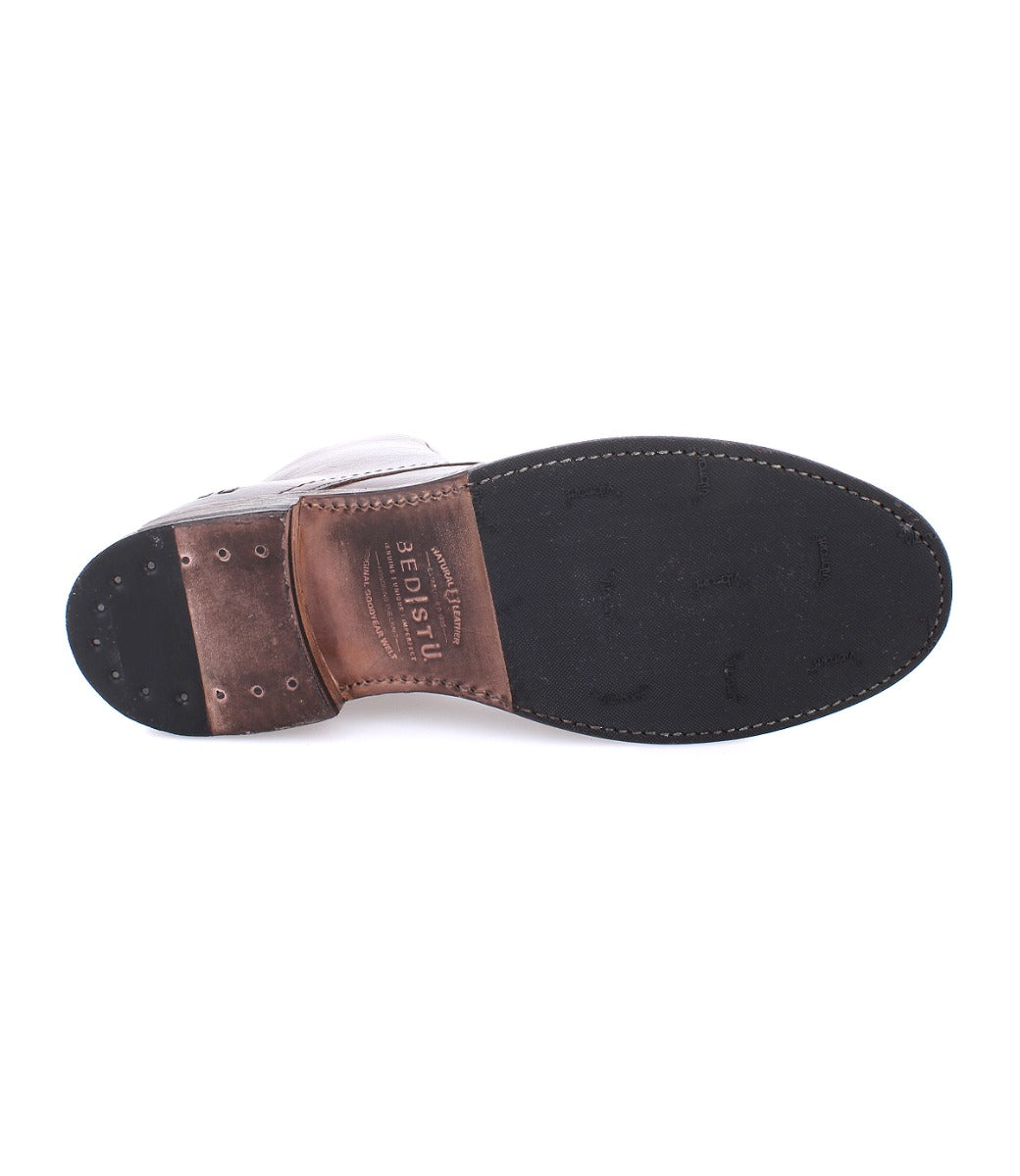 A pair of Bed Stu men's shoes with a brown leather sole.