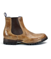 A brown leather Bed Stu Brady Trek boot with a dark elastic side panel and rugged black Vibram outsole, shoe facing left.