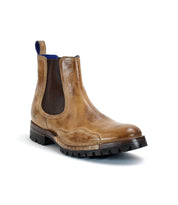 A single brown leather Chelsea boot with elastic side panels and a rugged Vibram outsole, displayed against a white background. The Brady Trek by Bed Stu.