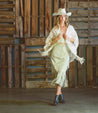 A woman wearing the Brie II cowboy hat and skirt by Bed Stu.