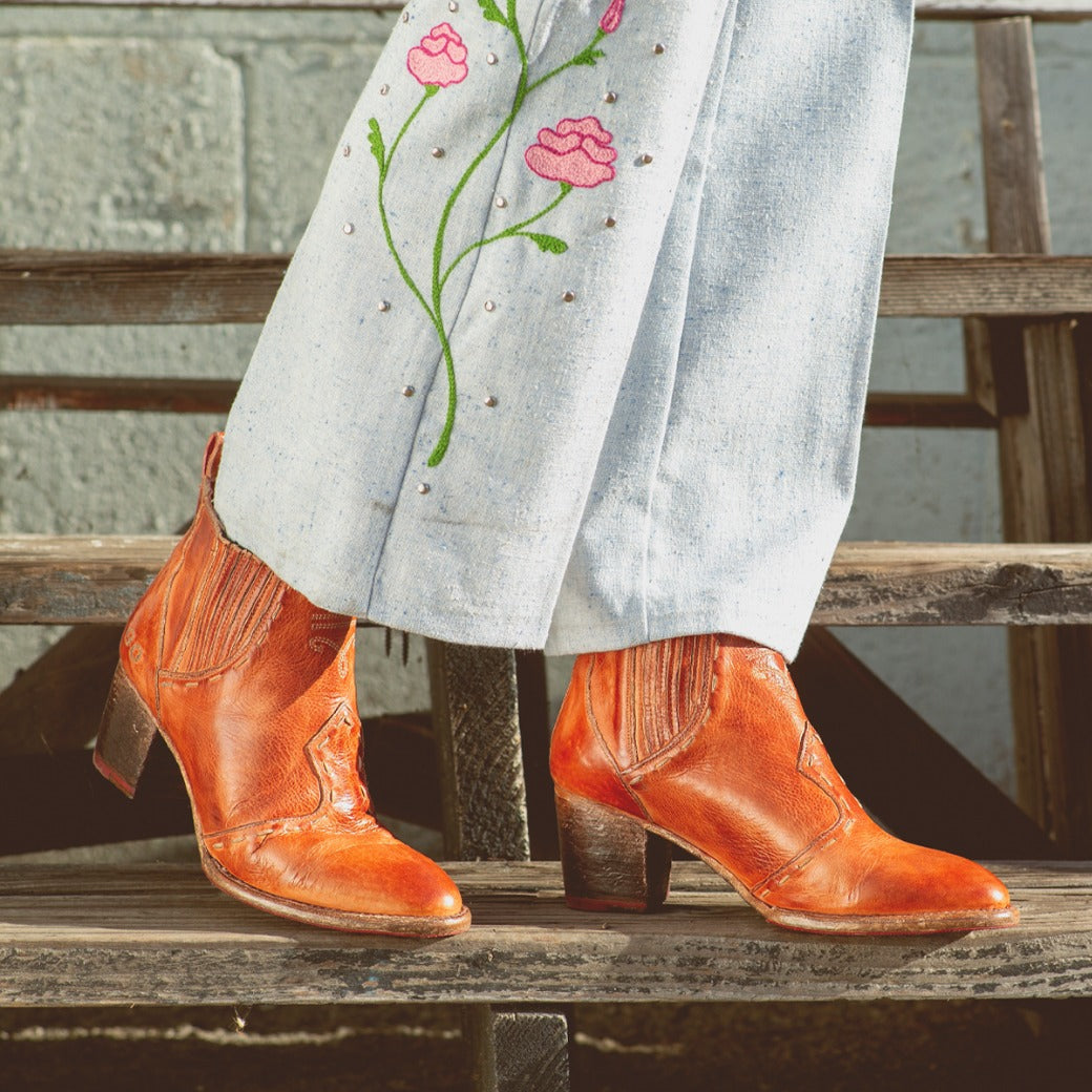 A woman wearing a pair of Bed Stu Brie II boots and jeans.