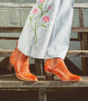 A woman wearing a pair of Bed Stu Brie II boots and jeans.