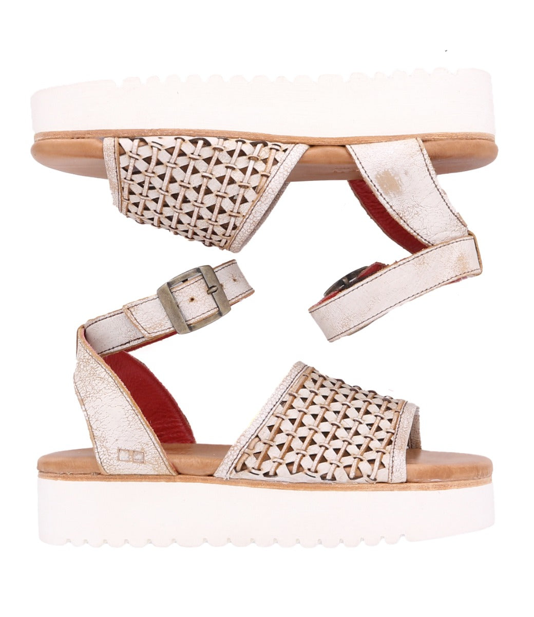 A pair of Brisa white sandals with braided straps by Bed Stu.