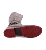 A pair of Bristol boots by Bed Stu with red soles on a white background.