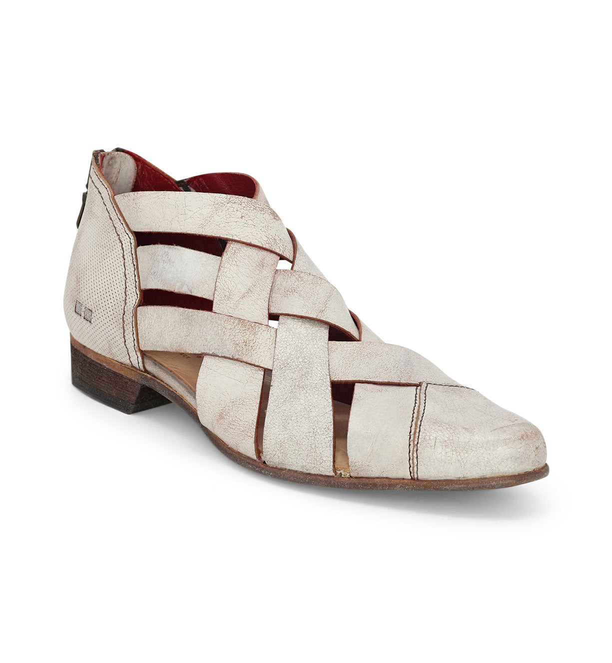 A white women's shoe with a woven strap, called Brittany by Bed Stu.