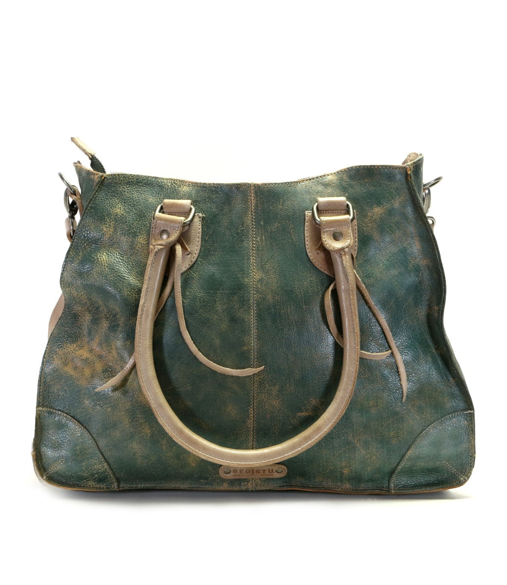 A teal Bed Stu Bruna vegetable tanned leather bag with straps.