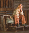 A woman sitting beside a teal Bed Stu Bruna leather bag.