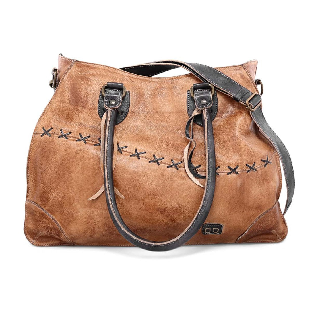 A woman carrying a tan Bed Stu Bruna leather bag with black straps.