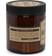 A jar of Bed|Stü Revive Leather Care Package leather conditioning cream with labels detailing a blend of shea butter, coconut oil, and beeswax. Instructions and warnings are visible.