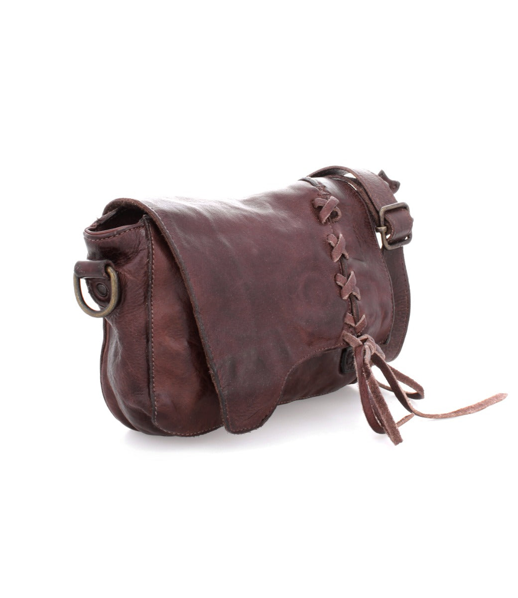 A brown leather crossbody bag with tassels called the Buffy by Bed Stu.
