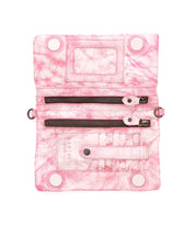 Unlock the versatility of Bed Stu's Cadence wallet, showcasing a marbled pink design with a 3-in-1 functionality, multiple zippers, card slots, and snap closures.