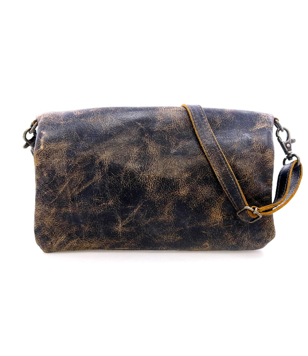 The Cadence shoulder bag by Bed|Stü features distressed brown vegetable-tanned leather, a long adjustable strap, and metal clasps, shown here against a white background.