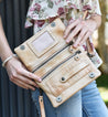 A woman holding a Cadence crossbody bag by Bed Stu.