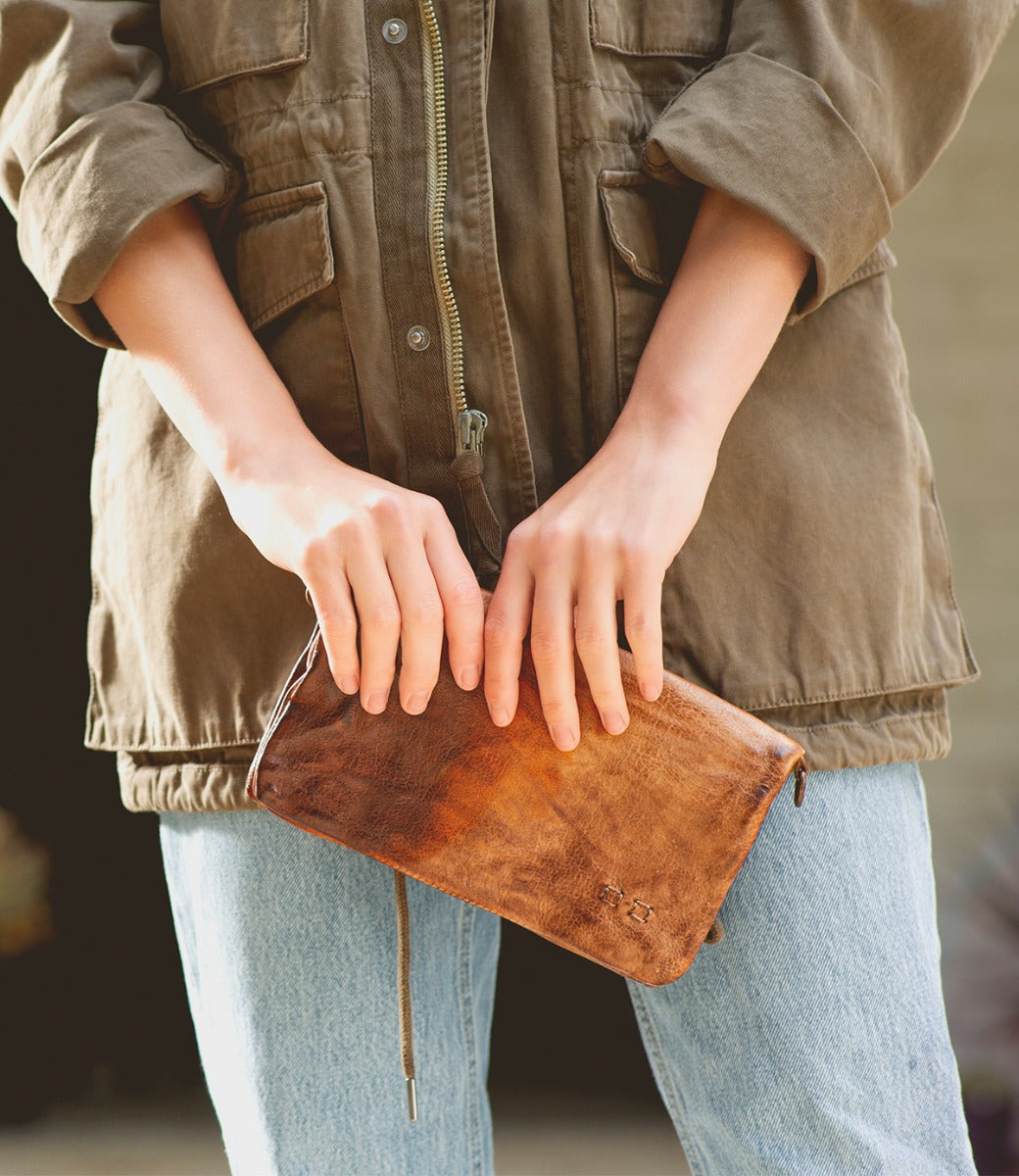 A woman holding a Cadence clutch by Bed Stu.