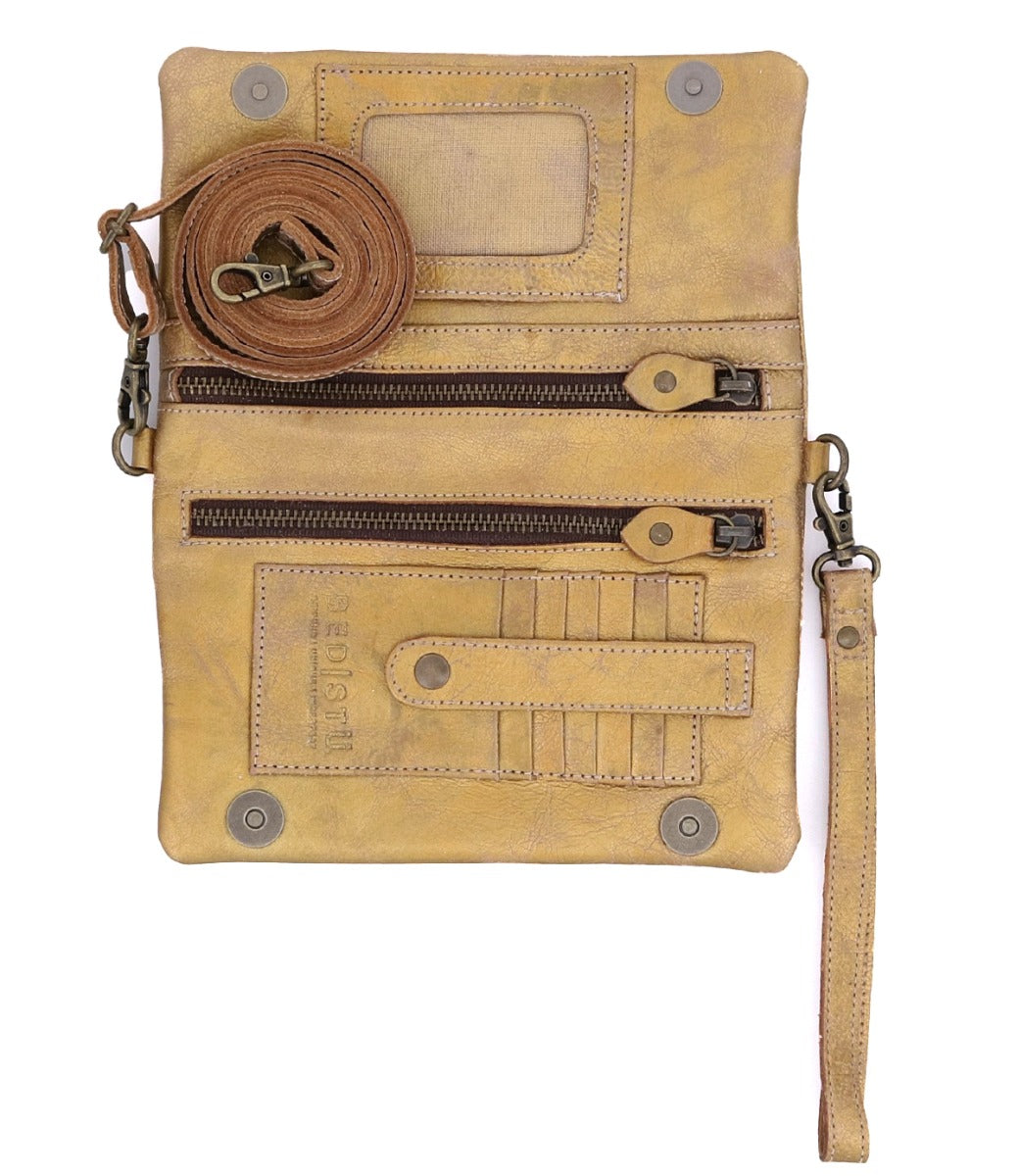 A gold Cadence wallet with a Bed Stu leather strap attached to it.