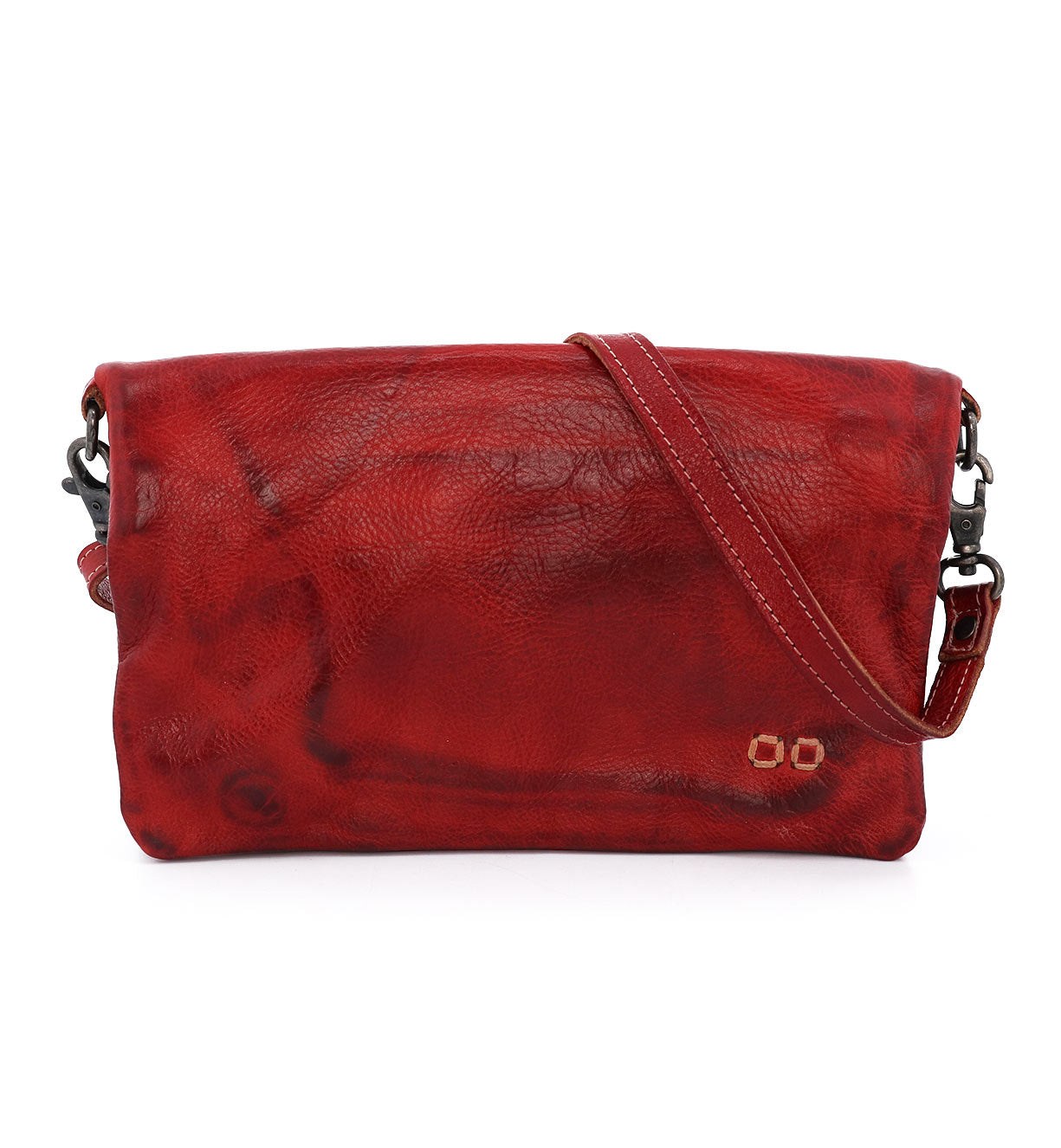 The Cadence by Bed|Stü is a red leather crossbody clutch featuring a textured vegetable-tanned leather surface, a fold-over flap, and an adjustable strap, displayed against a white background.