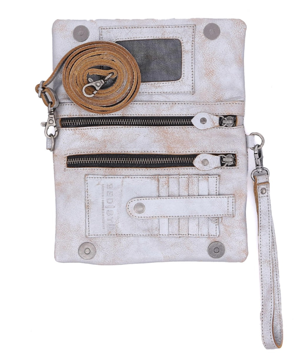 Inside a Cadence silver leather clutch bag by Bed Stu.