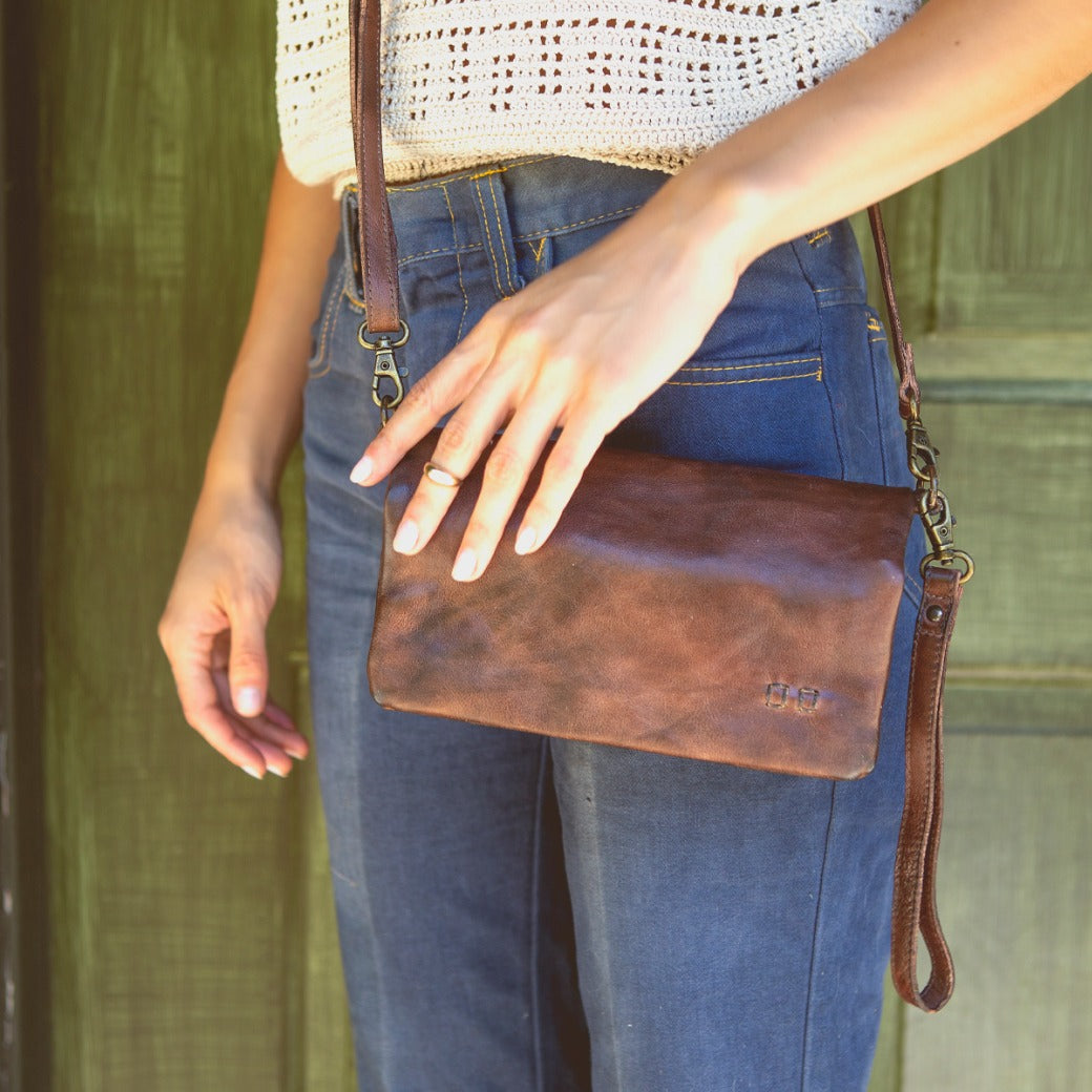 A woman wearing a Bed Stu Cadence purse.