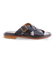 A black slip on Italian leather sandal with a gold buckle product shot.