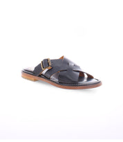 A black slip on Italian leather sandal with a gold buckle product shot.