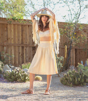 A woman wearing Bed Stu tan Callista leather sandals.