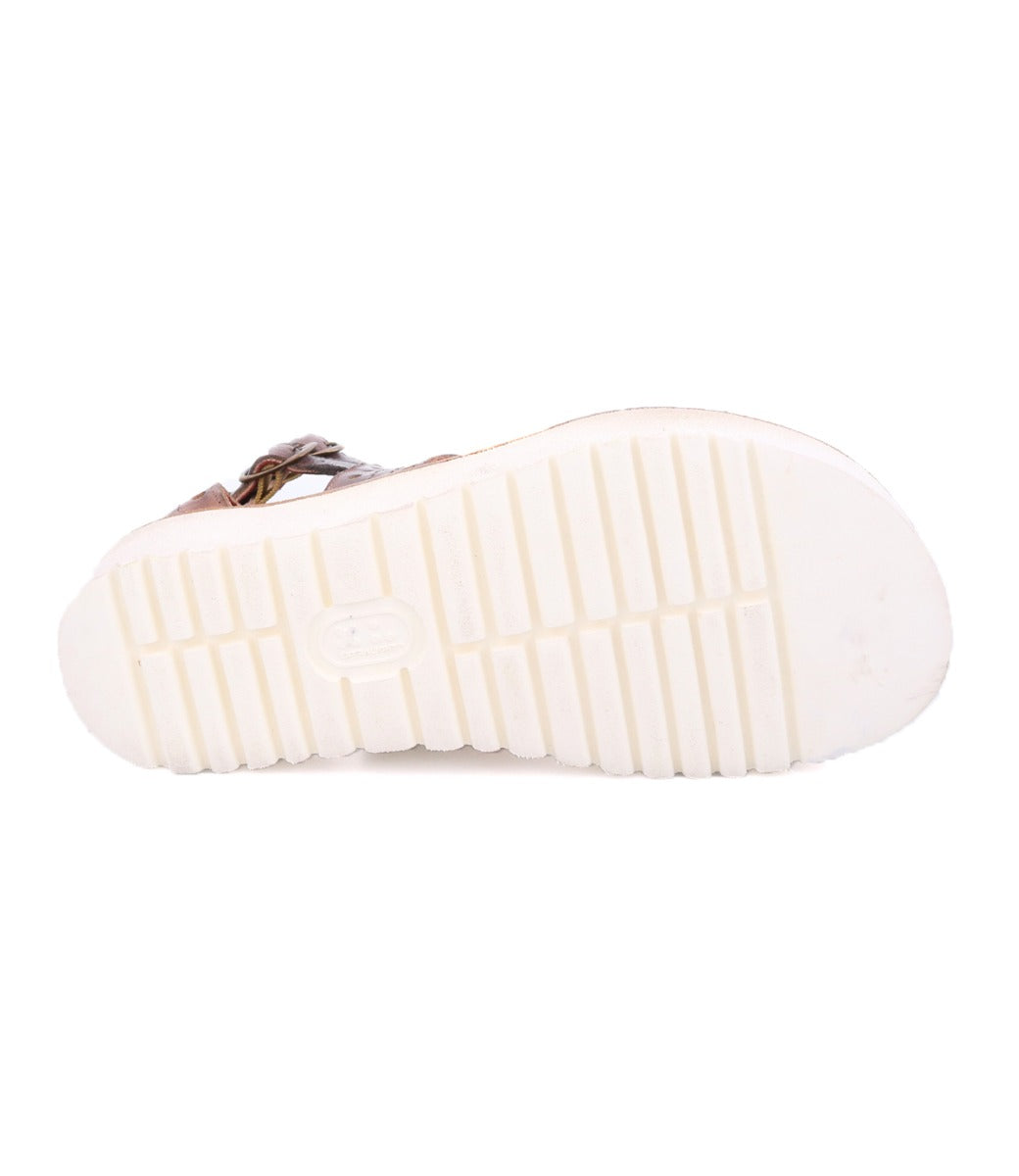A pair of Bed Stu Camden women's sandals with white soles on a white background.