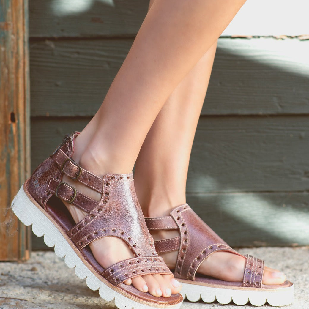A woman's feet in a pair of Bed Stu Camden sandals.