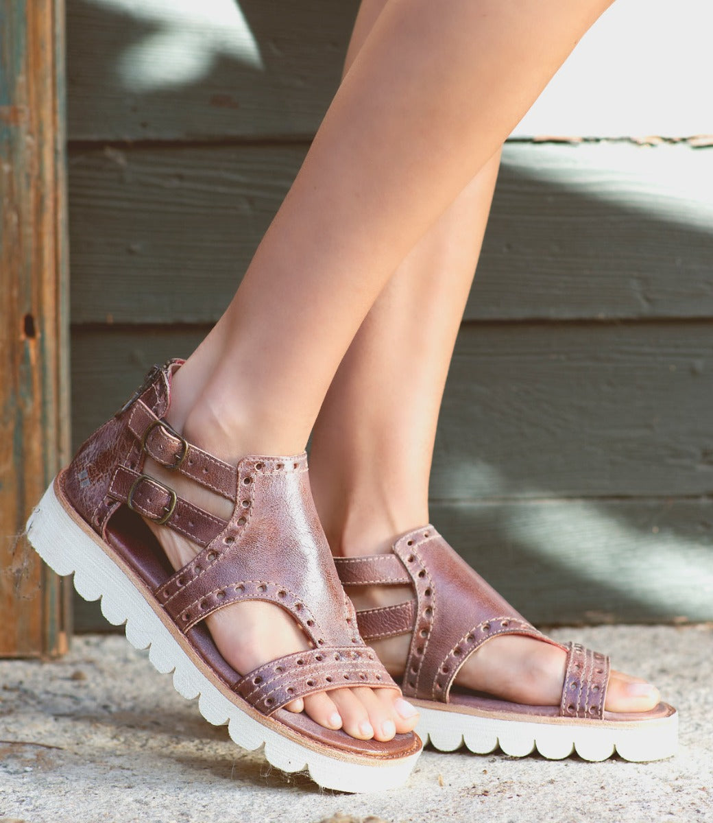 A woman's feet in a pair of Bed Stu Camden sandals.