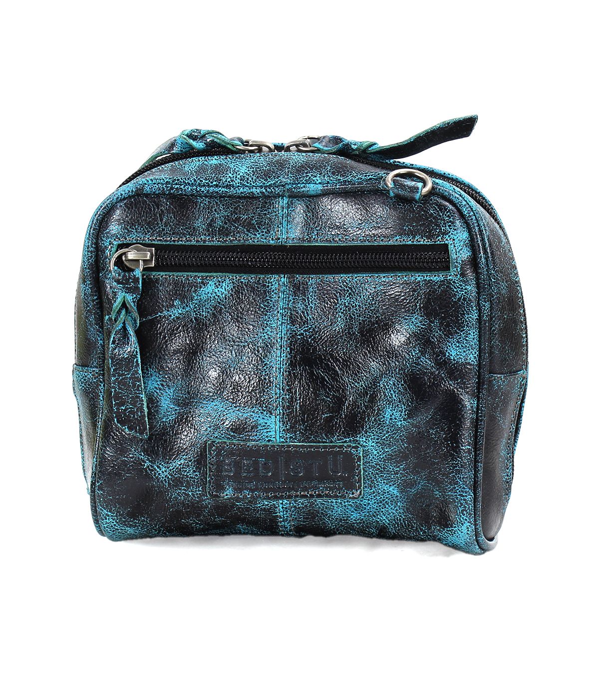 A worn black and teal leather compact bag, called Capture by Bed Stu, features a zippered front pocket, artisan-made finishes, and a visible brand logo on the bottom panel.