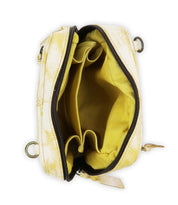 The Capture by Bed Stu is an open yellow handbag, made from eco-friendly leather, featuring a zipper that reveals its spacious interior with multiple pockets.
