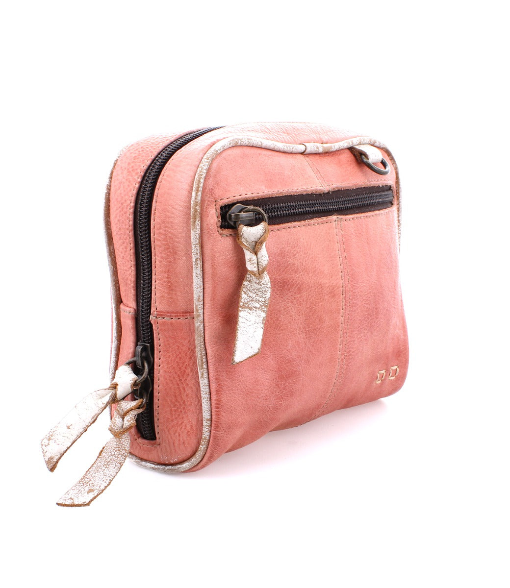 A pink leather Capture cosmetic bag with a zipper by Bed Stu.