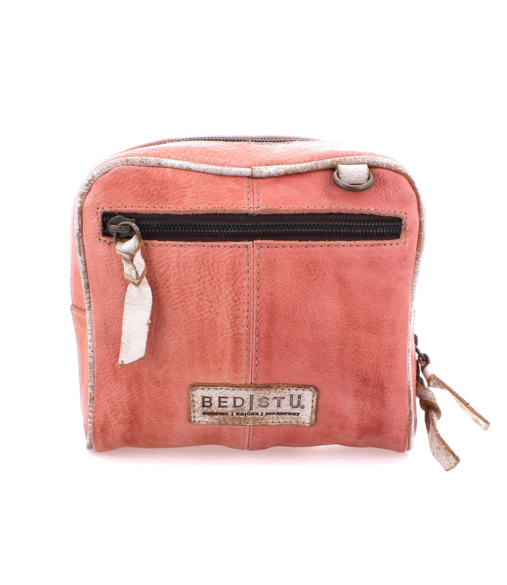 A pink Capture cosmetic bag with a zipper, from the Bed Stu brand.