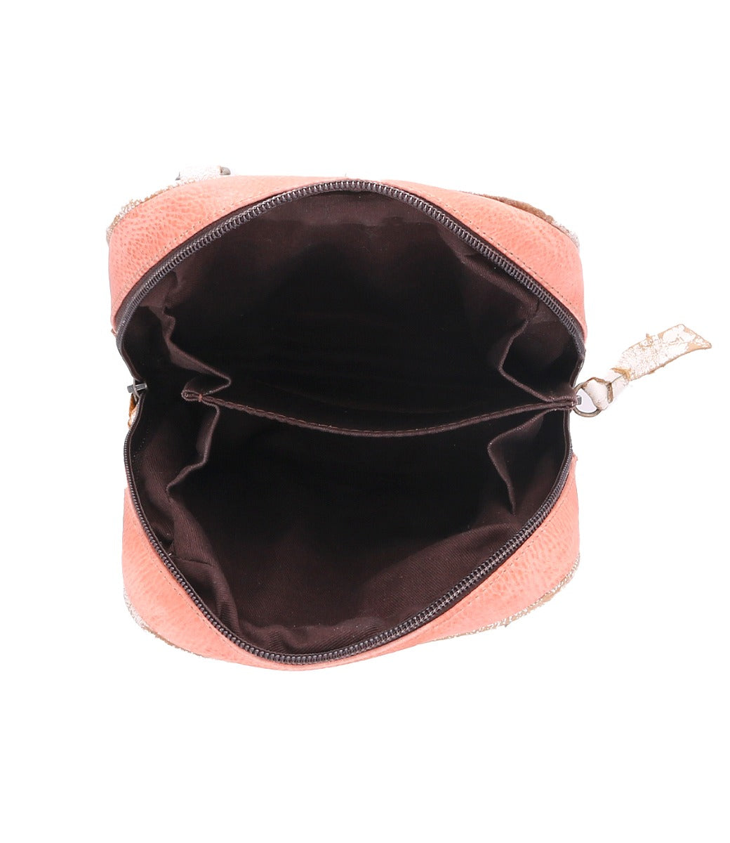 The inside of a Capture pink purse with a zipper by Bed Stu.