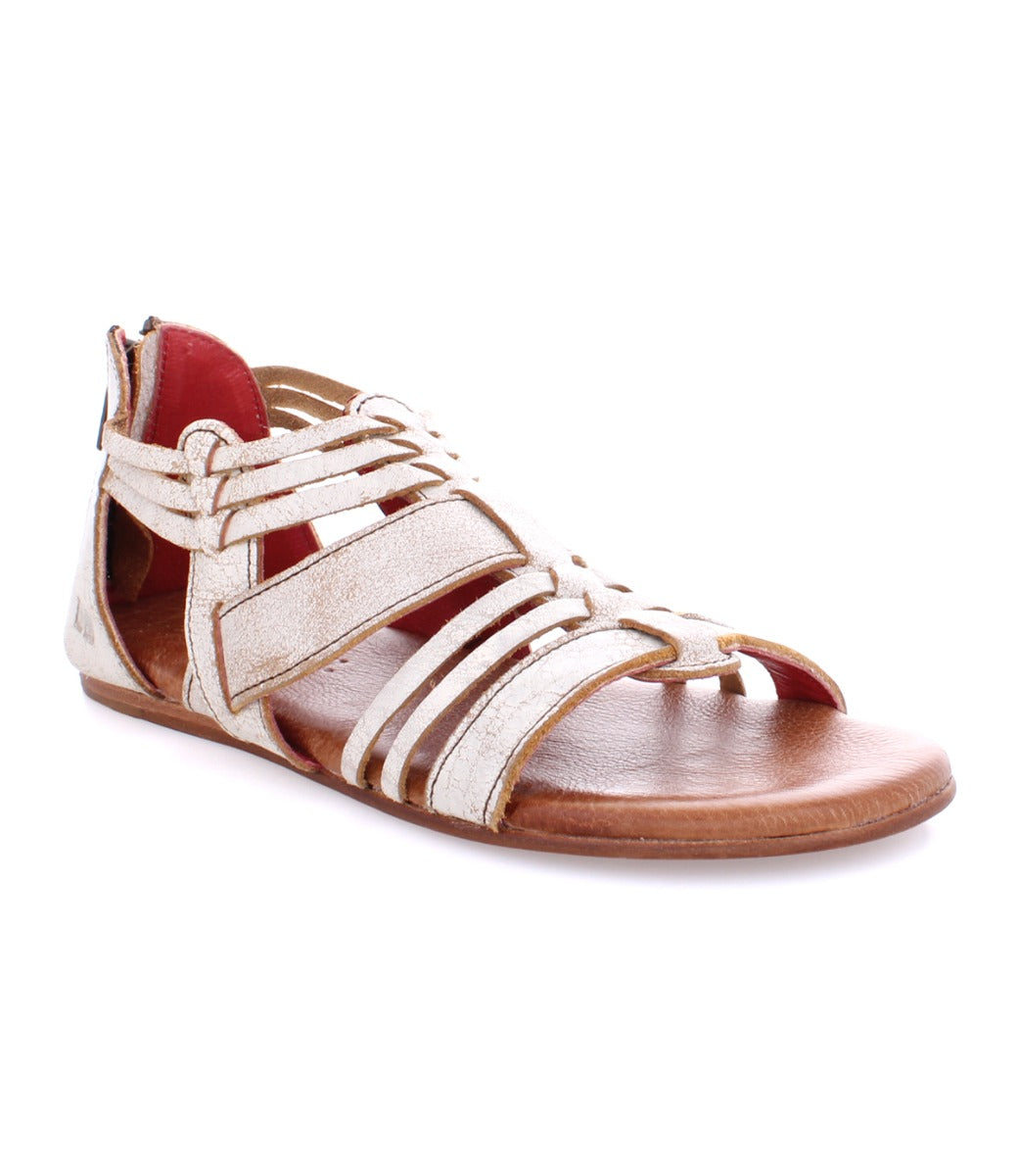 A women's white Bed Stu sandal with red straps.