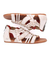 A pair of Bed Stu white sandals with red straps, specifically the Cara style.