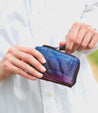 A person is holding a bed Stu Carrie wallet.