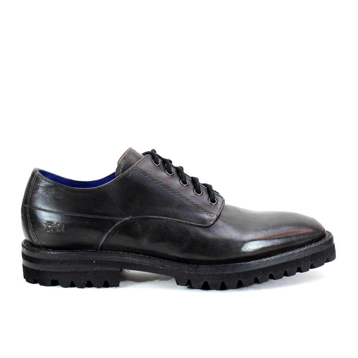 The Carter by Bed Stu is a black leather dress shoe with a rugged sole and lace-up design, crafted using Goodyear welt construction.